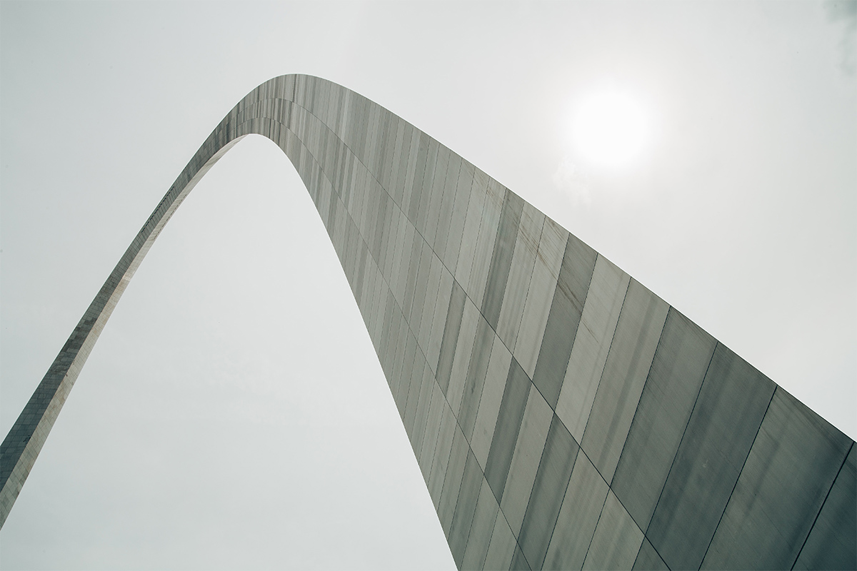 Gateway Arch under cloudy skies.